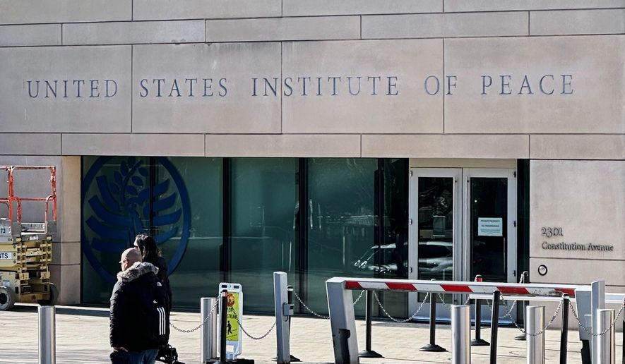 FILE - President Donald Trump's name is seen on the United State Institute of Peace building, Dec. 3, 2025 in Washington. (AP Photo/Matthew Lee, File)