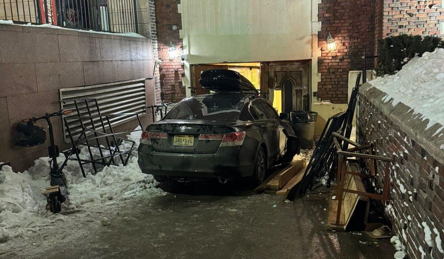 This photo provided by Rabbi Yaacov Behrman shows a car that crashed into the Chabad Lubavitch world headquarters in New York City, late Wednesday, Jan.28, 2026. (@ChabadLubavitch/UGC via AP)