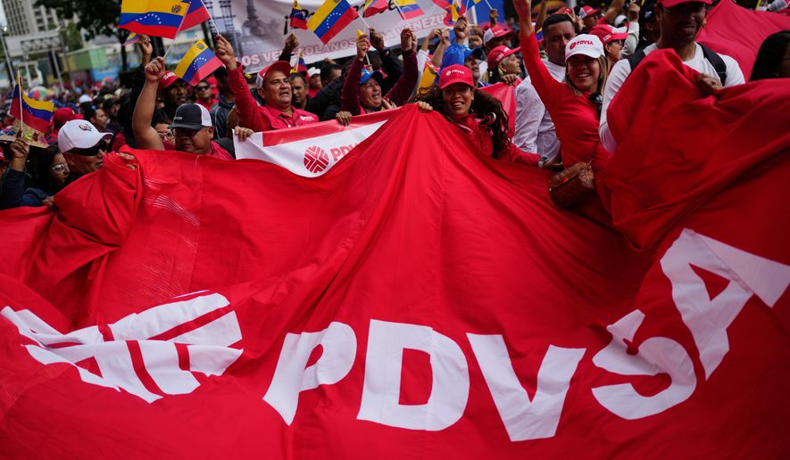 Workers of Venezuela's state-owned PDVSA oil company rally to back an oil reform bill proposed by acting President Delcy Rodriguez to loosen state control and open the industry to private and foreign investment in Caracas, Venezuela, Thursday, Jan. 29, 2026. (AP Photo/Ariana Cubillos)