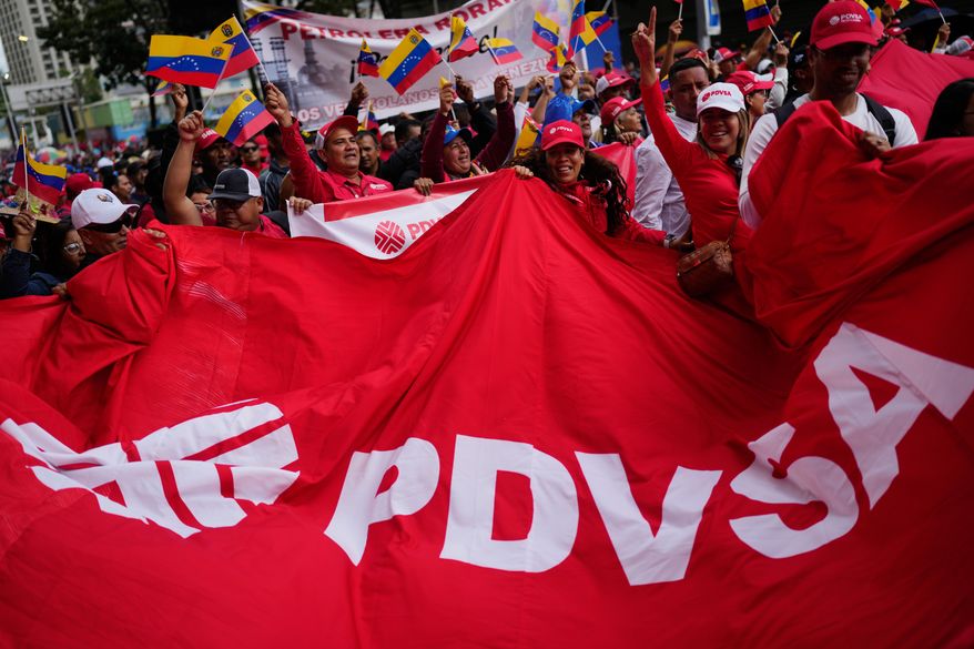 Workers of Venezuela's state-owned PDVSA oil company rally to back an oil reform bill proposed by acting President Delcy Rodriguez to loosen state control and open the industry to private and foreign investment in Caracas, Venezuela, Thursday, Jan. 29, 2026. (AP Photo/Ariana Cubillos)