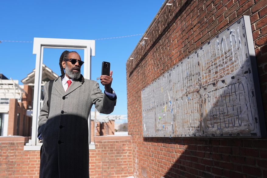 Attorney Michael Coard makes a social media post at the now removed explanatory panels that were part of an exhibit on slavery at President's House Site in Philadelphia, Friday, Jan. 30, 2026. (AP Photo/Matt Rourke)