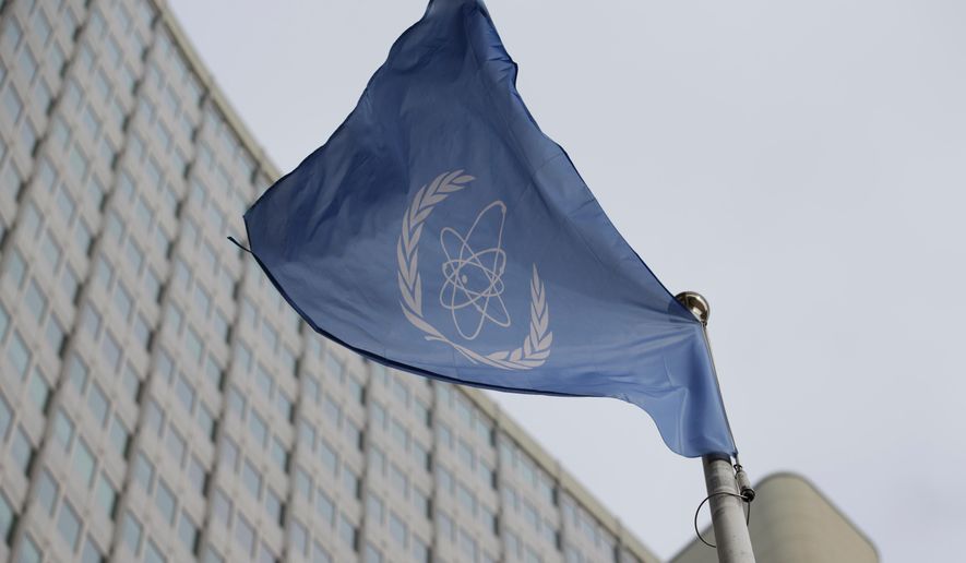 FILE - The flag of the International Atomic Energy Agency flies in front of its headquarters during an IAEA Board of Governors meeting in Vienna, Austria, on Feb. 6, 2023. (AP Photo/Heinz-Peter Bader, File)