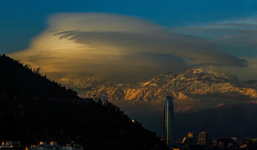 Clouds hover over the Andes Mountains in Santiago, Chile, June 19, 2024. (AP Photo/Esteban Felix, File)