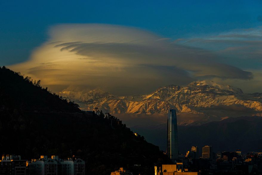 Clouds hover over the Andes Mountains in Santiago, Chile, June 19, 2024. (AP Photo/Esteban Felix, File)