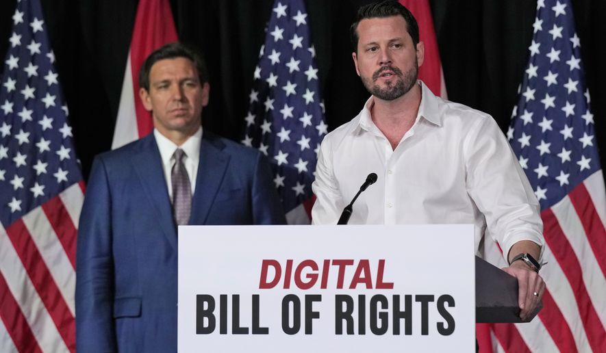 Seth Dillon, right, owner and operator of a satire site called the Babylon Bee, speaks as Florida Gov. Ron DeSantis looks on after announcing a proposal for Digital Bill of Rights, Wednesday, Feb. 15, 2023, at Palm Beach Atlantic University in West Palm Beach, Fla. (AP Photo/Wilfredo Lee)
