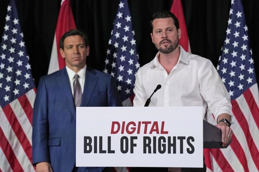 Seth Dillon, right, owner and operator of a satire site called the Babylon Bee, speaks as Florida Gov. Ron DeSantis looks on after announcing a proposal for Digital Bill of Rights, Wednesday, Feb. 15, 2023, at Palm Beach Atlantic University in West Palm Beach, Fla. (AP Photo/Wilfredo Lee)