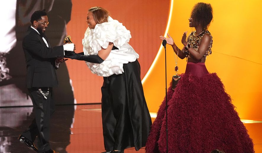 Kendrick Lamar, left, accepts the award for best rap album for "GNX" from Queen Latifah, and Doechii during the 68th annual Grammy Awards on Sunday, Feb. 1, 2026, in Los Angeles. (AP Photo/Chris Pizzello)