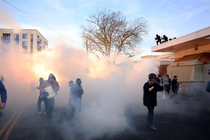 Federal agents lobbed tear gas and flash bangs at protesters in front of the ICE building on Jan. 31, 2026, in Portland, Ore. (Allison Barr/The Oregonian via AP)