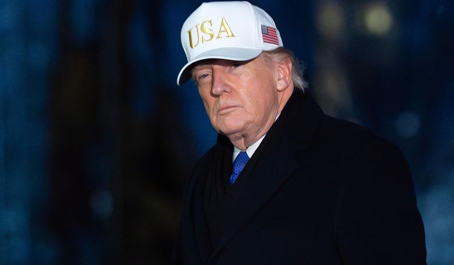President Donald Trump walks on the South Lawn upon his arrival to the White House, Sunday, Feb. 1, 2026, in Washington. (AP Photo/Jose Luis Magana)
