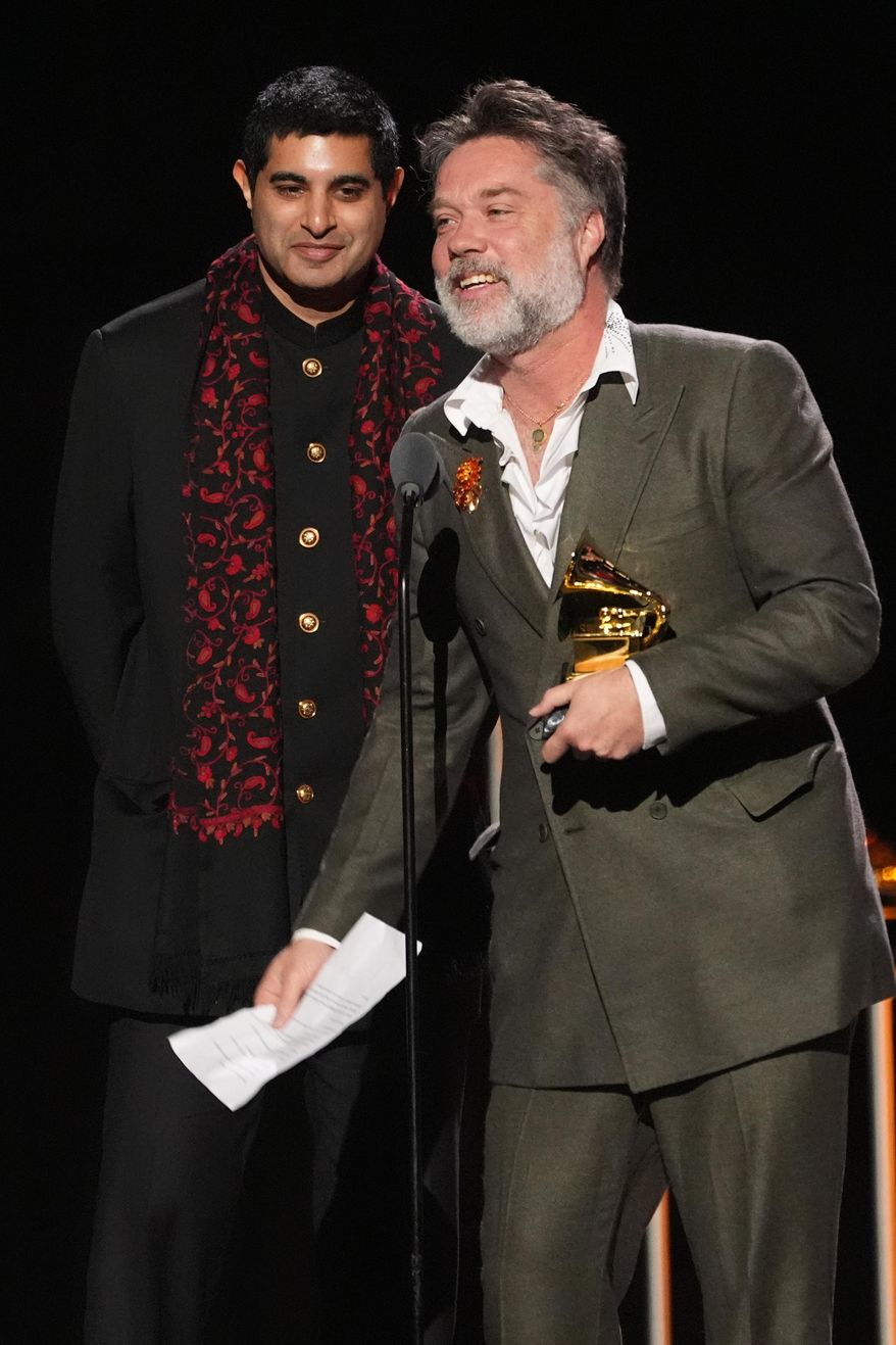 Rufus Wainwright, right, accepts the award for best audio book, narration, and storytelling recording for "Meditations: The Reflections of His Holiness The Dalai Lama" on behalf of Dalai Lama during the 68th annual Grammy Awards on Sunday, Feb. 1, 2026, in Los Angeles. (AP Photo/Chris Pizzello)