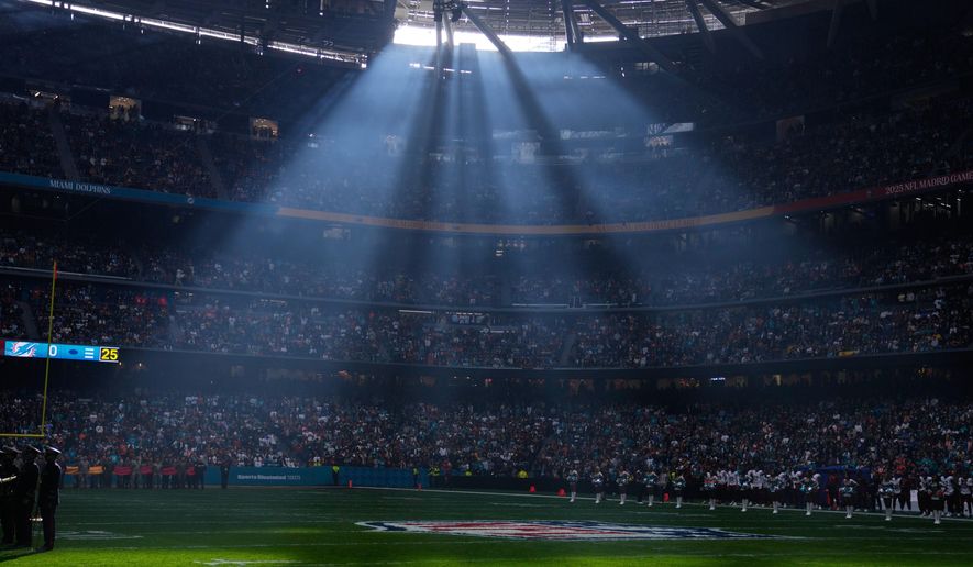 FILE - A shaft of sunlight streams into the stadium before an NFL football game between the Washington Commanders and the Miami Dolphins in Madrid, Spain, Sunday, Nov. 16, 2025. (AP Photo/Manu Fernandez, file)