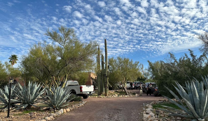 Law enforcement officers are present outside the home of Nancy Guthrie, the mother of "Today" host Savannah Guthrie, near Tucson, Ariz., Monday, Feb. 2, 2026. (AP Photo/Sejal Govindarao)