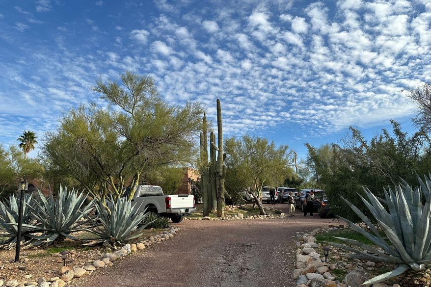Law enforcement officers are present outside the home of Nancy Guthrie, the mother of "Today" host Savannah Guthrie, near Tucson, Ariz., Monday, Feb. 2, 2026. (AP Photo/Sejal Govindarao)