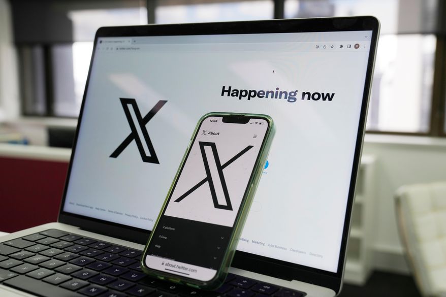 The opening page of X is displayed on a computer and phone, Oct. 16, 2023, in Sydney. (AP Photo/Rick Rycroft, File)