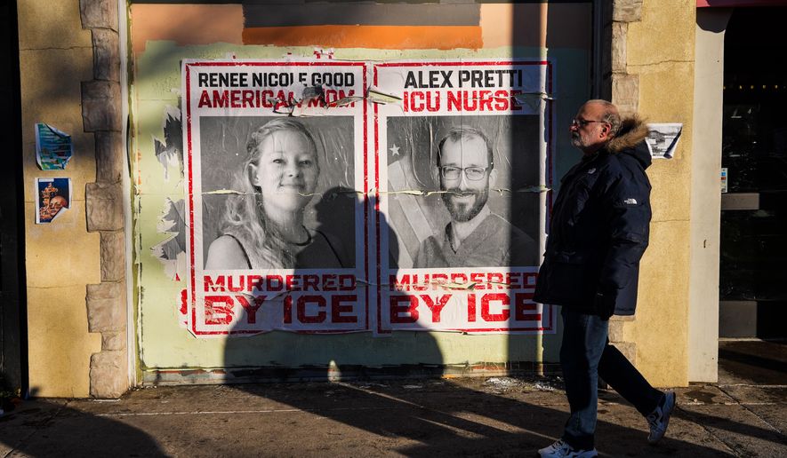 A man walks by posters of Renee Nicole Good and Alex Pretti, who were both fatally shot by federal agents, in Minneapolis, Saturday, Jan. 31, 2026. (AP Photo/Ryan Murphy)