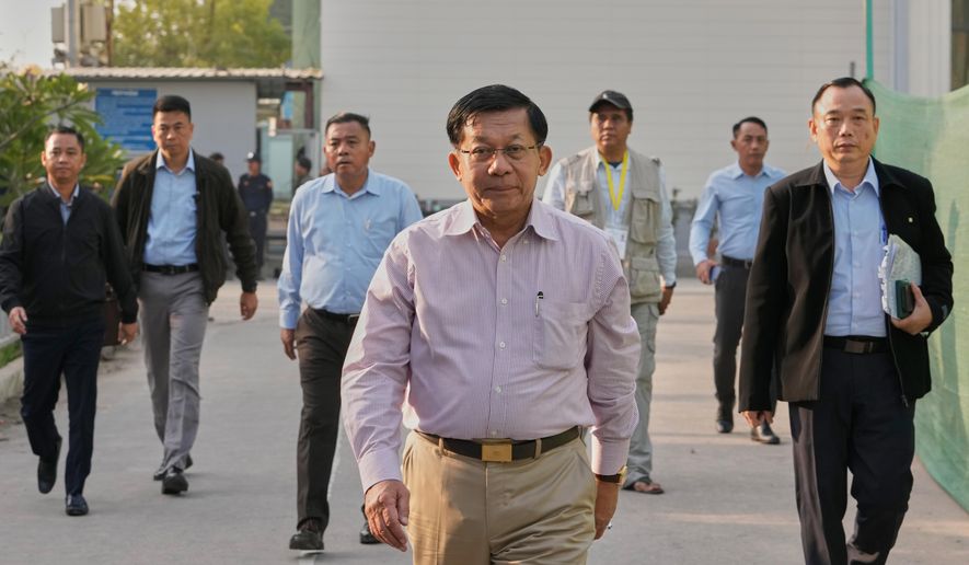 Myanmar military leader Senior Gen. Min Aung Hlaing, center, visits a polling station during the final round of general election in Mandalay, central Myanmar, Sunday, Jan. 25, 2026. (AP Photo/Aung Shine Oo)