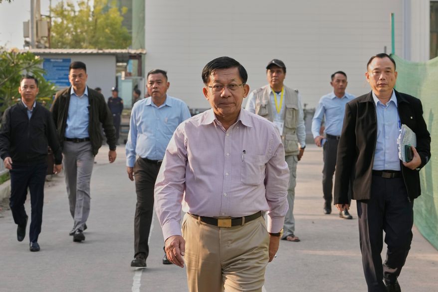 Myanmar military leader Senior Gen. Min Aung Hlaing, center, visits a polling station during the final round of general election in Mandalay, central Myanmar, Sunday, Jan. 25, 2026. (AP Photo/Aung Shine Oo)