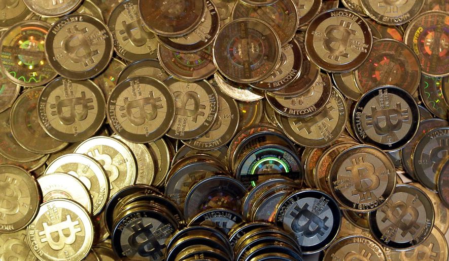 Bitcoin tokens are seen on April 3, 2013, in Sandy, Utah. (AP Photo/Rick Bowmer, File)
