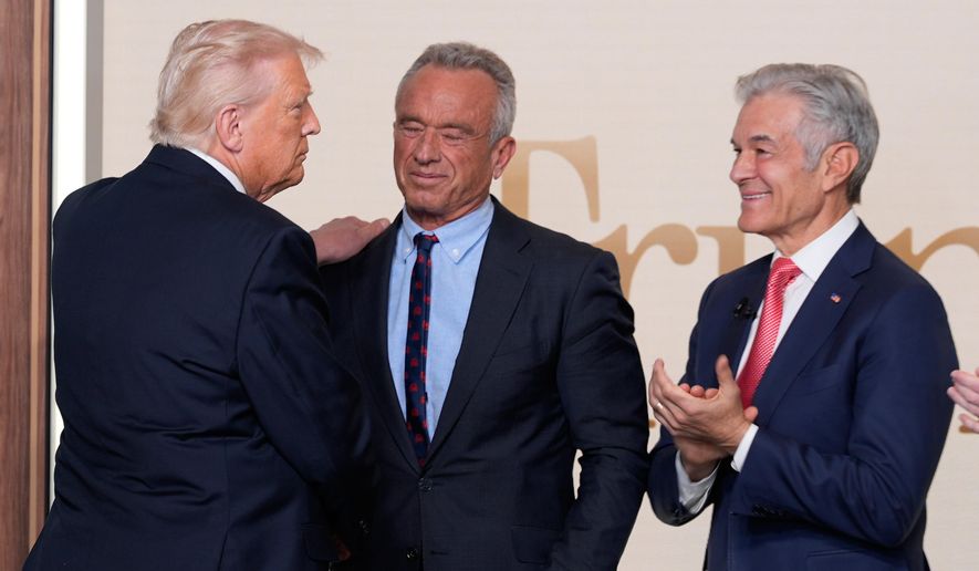 President Donald Trump greets Health and Human Services Secretary Robert F. Kennedy Jr. and Centers for Medicare & Medicaid Services administrator Dr. Mehmet Oz after an event about TrumpRx in the South Court Auditorium in the Old Eisenhower Executive Office Building on the White House campus, Thursday, Feb. 5, 2026, in Washington. (AP Photo/Alex Brandon) ** FILE **