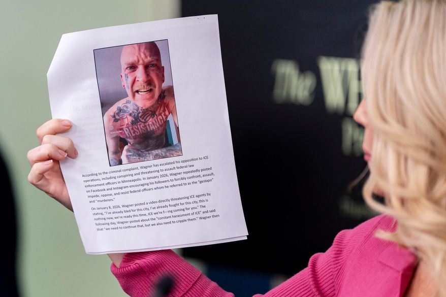 White House press secretary Karoline Leavitt holds a photo of Kyle Wagner, as she speaks with reporters in the James Brady Press Briefing Room at the White House, Thursday, Feb. 5, 2026, in Washington. (AP Photo/Alex Brandon)