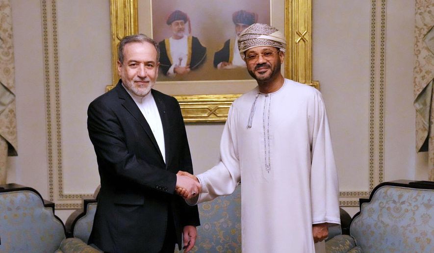 In this photo released by the Iranian Foreign Ministry, Iranian Foreign Minister Abbas Araghchi, left, shakes hands with his Omani counterpart Sayyid Badr al- Busaidi during their meeting prior to Iran and the U.S. negotiations, in Muscat, Oman, Friday, Feb. 6, 2026. (Iranian Foreign Ministry via AP)