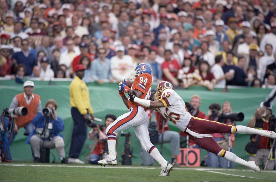 Washington Redskins cornerback Barry Wilburn (45) tries to stop Denver Broncos Ricky Nattiel (84) from getting into the endzone after Nattiel hauled in pass from quarterback John Elway during first quarter of Super Bowl XXII, Sunday, Jan. 31, 1988 in San Diego. Nattiel scored on the 56-yard play. (AP Photo/Lenny Ignelzi)