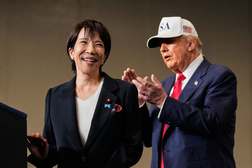 Japanese Prime Minister Sanae Takaichi, with President Donald Trump, reacts as she was speaking to members of the military aboard the USS George Washington, an aircraft carrier docked at an American naval base, in Yokosuka, on Oct. 28, 2025. (AP Photo/Mark Schiefelbein, File)
