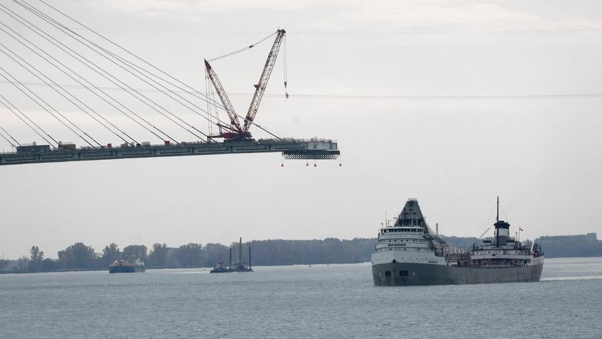 The Saginaw passes construction on the Gordie Howe International Bridge on the Detroit River connecting Windsor, Ontario and Detroit, Oct. 25, 2023. (AP Photo/Paul Sancya, File)