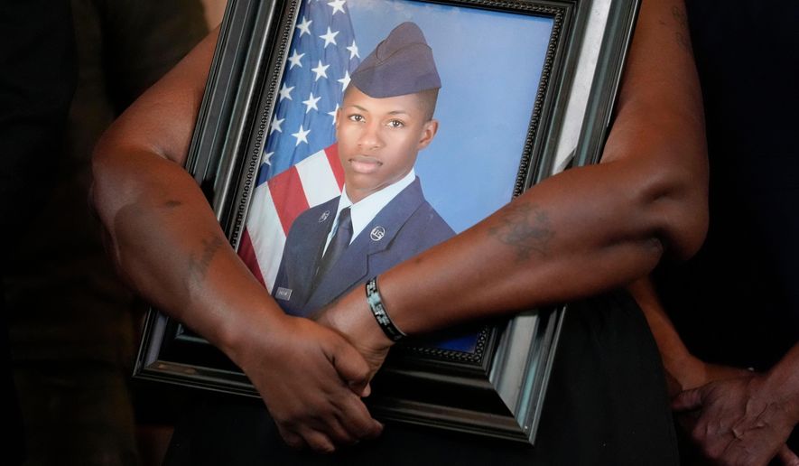 Chantemekki Fortson, mother of slain U.S. Air Force senior airman Roger Fortson, holds a photo of her son during a news conference with attorney Ben Crump on June 3, 2024, in Atlanta. (AP Photo/Brynn Anderson, File)