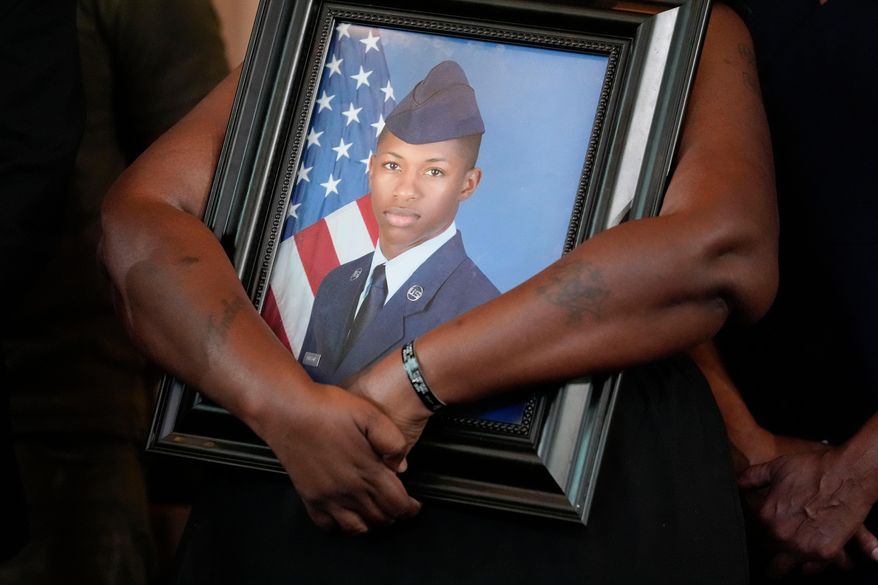 Chantemekki Fortson, mother of slain U.S. Air Force senior airman Roger Fortson, holds a photo of her son during a news conference with attorney Ben Crump on June 3, 2024, in Atlanta. (AP Photo/Brynn Anderson, File)