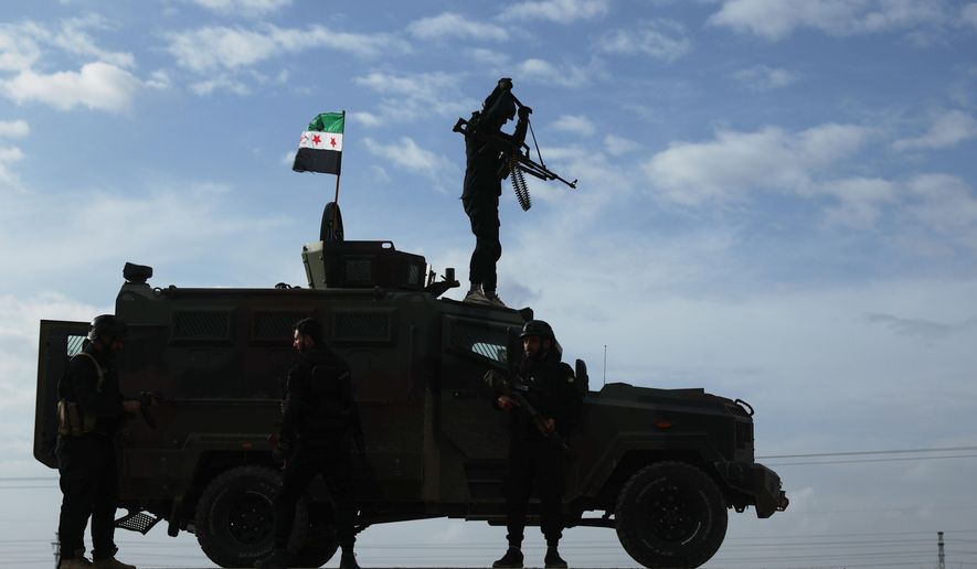 A vehicle pauses as a convoy of Syria's Interior Ministry forces passes through en route to the town of Qamishli, where the forces deploy under a ceasefire agreement with the Kurdish-led Syrian Democratic Forces (SDF), near the village of Mazraat al-Nahar, northeastern Syria, Tuesday, Feb. 3, 2026. (AP Photo/Ghaith Alsayed) ** FILE **