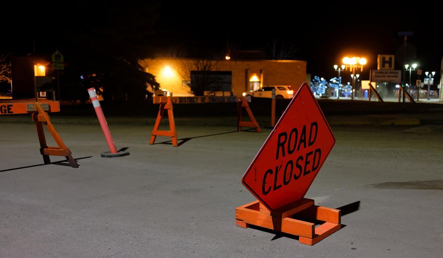 The road is blocked off before the Tumbler Ridge Secondary School, with the Tumbler Ridge Health Centre in the background, in Tumbler Ridge, B.C., Canada, on Wednesday, Feb. 11, 2026. (Jesse Boily/The Canadian Press via AP)
