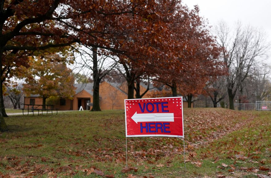 A "Vote Here" sign is seen on Election Day on Nov. 5, 2024, at Perfect Games in Ames, Iowa. (AP Photo/Bryon Houlgrave, File)