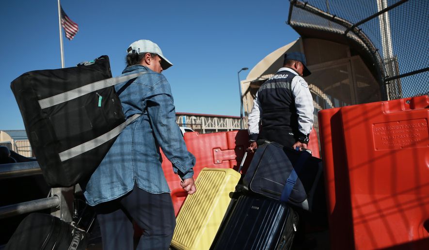 People cross the Paso del Norte International Bridge at the U.S.-Mexico border, in Ciudad Juarez, Mexico, Wednesday Feb. 11, 2026, on the border with El Paso, Texas. (AP Photo/Christian Chavez)