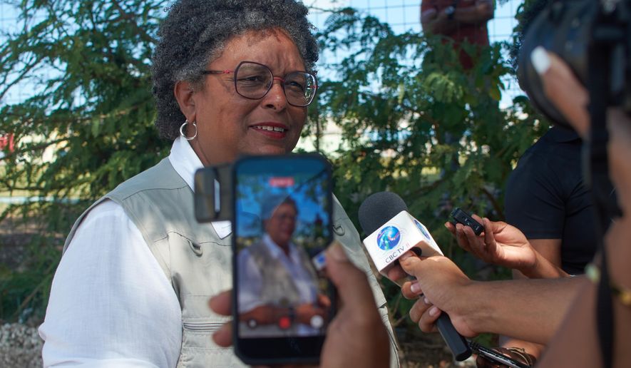 Barbados Prime Minister Mia Amor Mottley talks with the press after casting her ballot for the general election, as she runs for office again, in Bridgetown, Barbados, Wednesday, Feb. 11, 2026. (AP Photo/Kerrie Eversley)