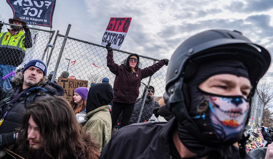 People attend an anti-ICE protest outside the Bishop Whipple Federal building in Minneapolis, Saturday, Feb. 7, 2026. (AP Photo/Ryan Murphy)