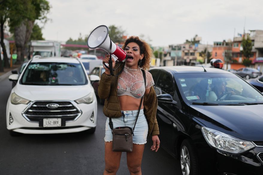 Carolina, a sex worker, protesting on Friday, Jan. 23, 2026. (AP Photo/Eduardo Verdugo)