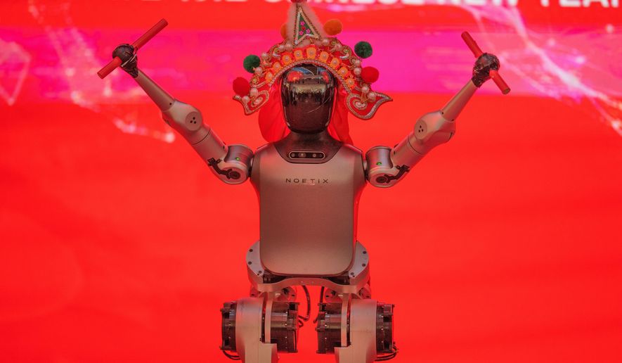 A humanoid robot wearing a traditional headdress is displayed during a media preview of a robotic temple fair ahead of Lunar New Year in Beijing, China, Friday, Feb. 13, 2026. (AP Photo/Vincent Thian)