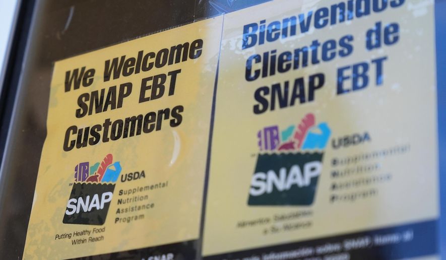 A SNAP EBT information sign is displayed outside of a convenience store in Baltimore, Monday, Nov. 10, 2025. (AP Photo/Stephanie Scarbrough) ** FILE **