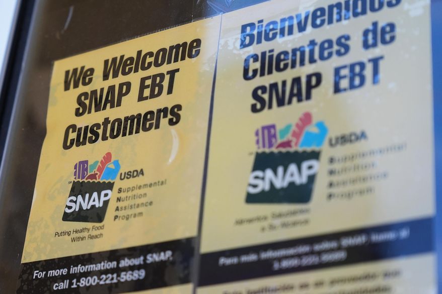 A SNAP EBT information sign is displayed outside of a convenience store in Baltimore, Monday, Nov. 10, 2025. (AP Photo/Stephanie Scarbrough) ** FILE **