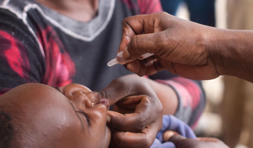 A healthcare worker administers polio vaccine to a child in the Ndirande Township of Blantyre, Malawi, Wednesday, Feb. 11, 2026. (AP Photo/Kenneth Jali)