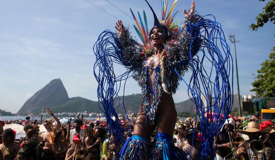 Raquel Poti performs on stilts during the Amigos da Onca Carnival street party, in Rio de Janeiro, Saturday, Feb. 14, 2026. (AP Photo/Bruna Prado)