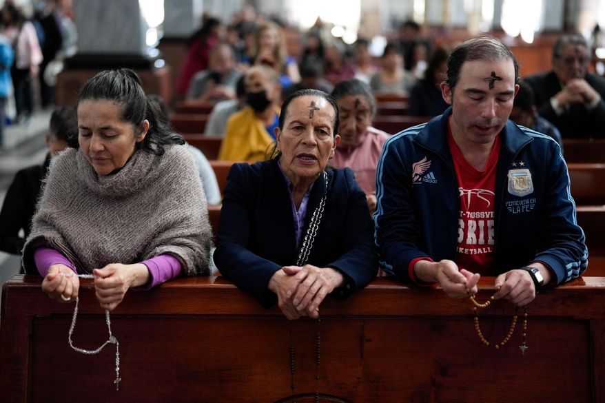 Catholics pray the rosary while a priest marks people's foreheads with ashes during Ash Wednesday Mass at the Church of the Divine Child in Bogota, Colombia, Wednesday, Feb. 14, 2024. (AP Photo/Fernando Vergara, File)