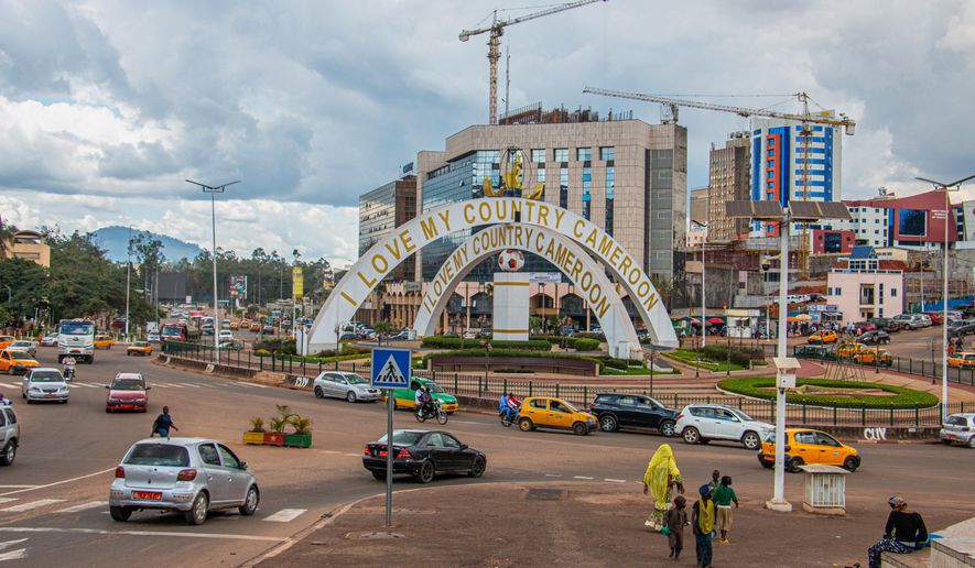 Cars drive through an intersection near a monument in Yaoundé, Cameroon, Sept. 12, 2025. (AP Photo / Welba Yamo Pascal, file)