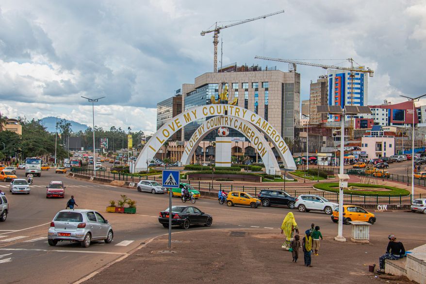 Cars drive through an intersection near a monument in Yaoundé, Cameroon, Sept. 12, 2025. (AP Photo / Welba Yamo Pascal, file)