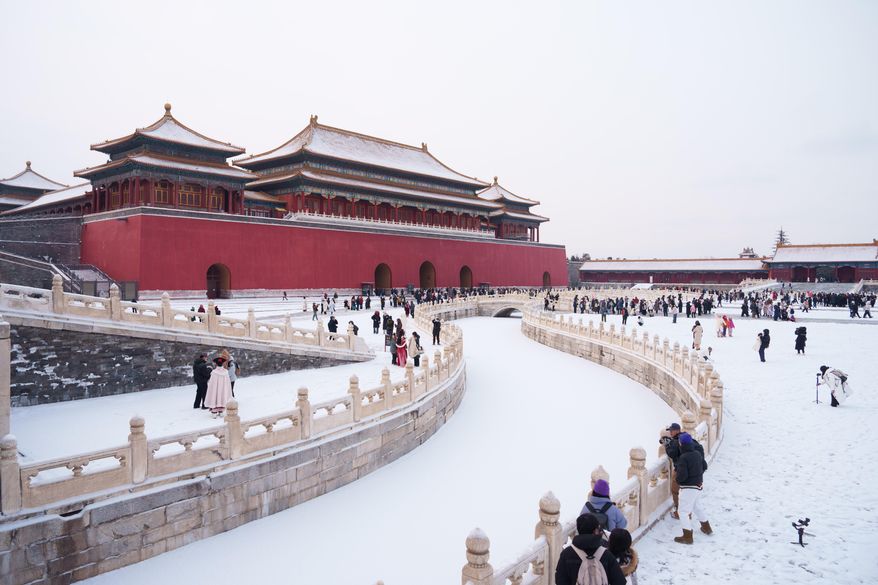 Tourists visit a snow-covered Forbidden City in Beijing, China, Sunday, Jan. 18, 2026. (AP Photo/Vincent Thian)