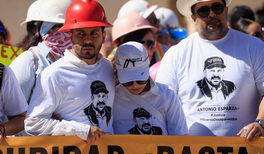 Relatives of Antonio Esparza, one of 10 mine workers abducted in neighboring Sinaloa state, during protest march in Hermosillo, Mexico, Saturday, Feb. 14, 2026. (AP Photo/Luis Gutierrez)