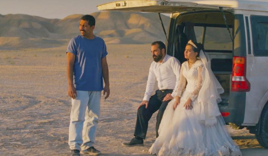 This image released by Neon shows, from left, Mohamad Ali Elyasmehr as Hamid, Majid Panahi as Ali, Hadis Pakbaten as Goli, in a scene from "It Was Just an Accident." (Neon via AP)