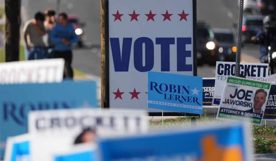Election signs crowd an intersection near a polling place, in Austin, Texas, Tuesday, Feb. 17, 2026. (AP Photo/Eric Gay)