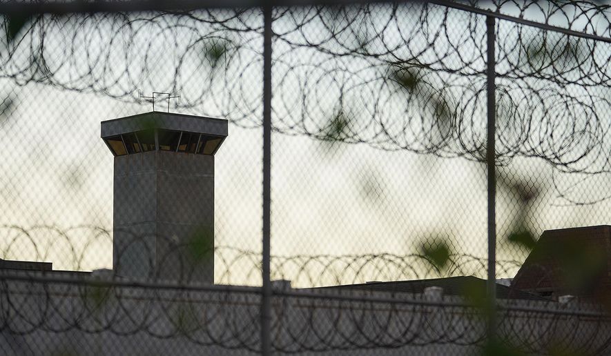 Barbed wire surrounds the Oahu Community Correctional Center in Honolulu in 2021. (Cory Lum/Honolulu Civil Beat via AP)
